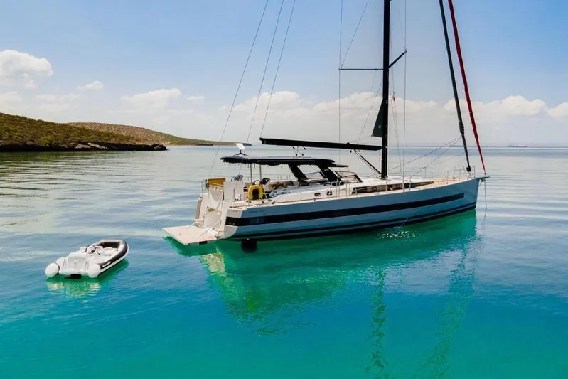 Dictador Yacht Photos Pics 2022 Beneteau Oceanis Yacht 62 anchored in clear turquoise waters.