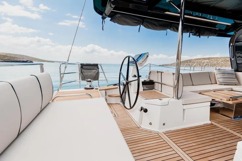 Dictador Yacht Photos Pics Luxurious 2022 Beneteau Oceanis Yacht 62 deck with elegant seating and steering wheel.