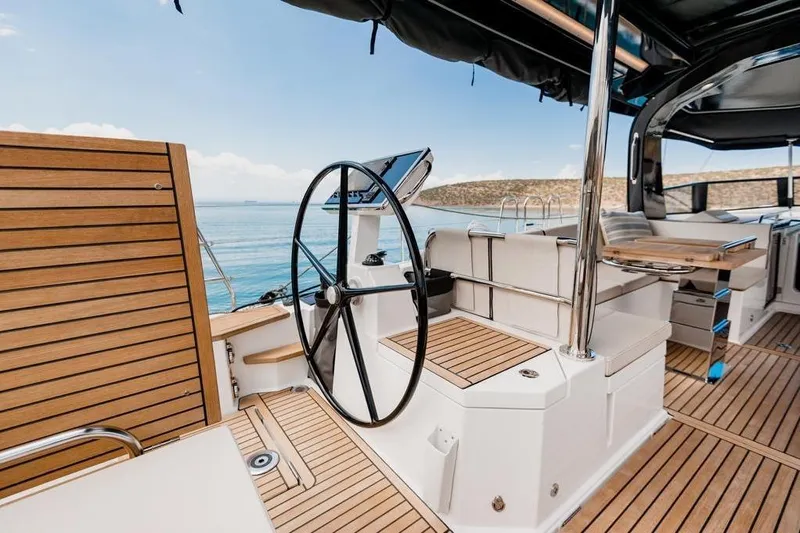 Dictador Yacht Photos Pics Luxurious 2022 Beneteau Oceanis Yacht 62 cockpit with teak decking and sleek steering wheel.