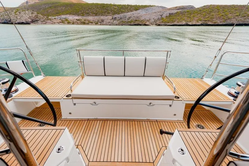 Dictador Yacht Photos Pics Luxury deck of 2022 Beneteau Oceanis Yacht 62 with scenic water view.