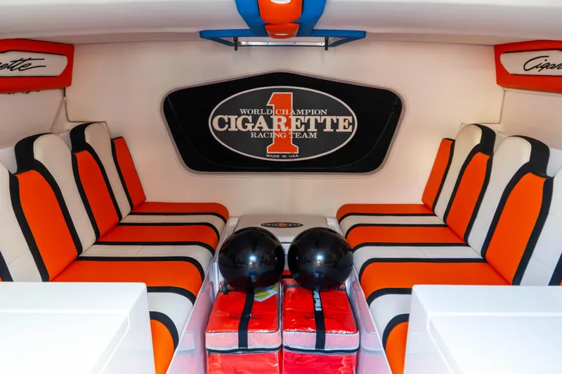  Yacht Photos Pics Interior of 2022 Cigarette 515 boat with orange and black seating, racing team logo.