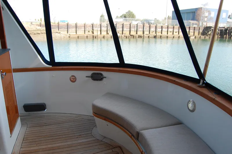 Shackleton Yacht Photos Pics 1982 Miller Marine North Sea Trawler interior with curved seating and waterfront view.