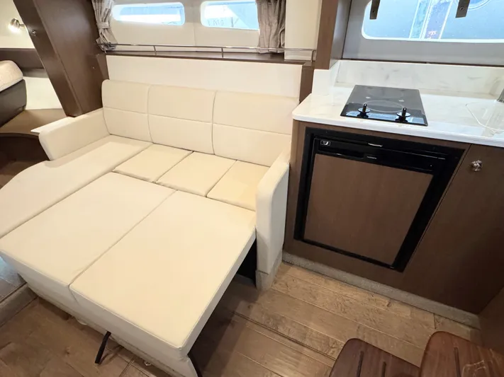  Yacht Photos Pics Interior of 2019 Sea Ray 350 Sundancer with sofa bed and kitchenette.