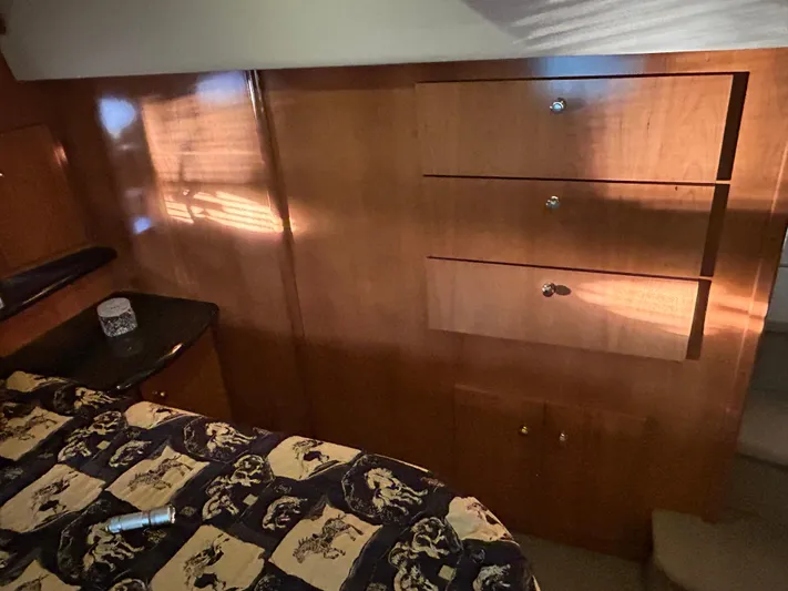  Yacht Photos Pics Interior of 2002 Carver 396 Aft Cabin MY with wood paneling and patterned bedding.
