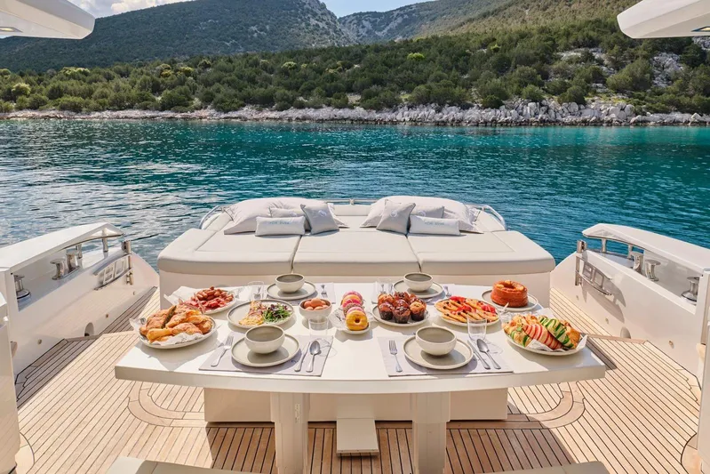 For Ever Yacht Photos Pics Luxury dining setup on a 2008 Pershing 80 yacht with scenic ocean view.