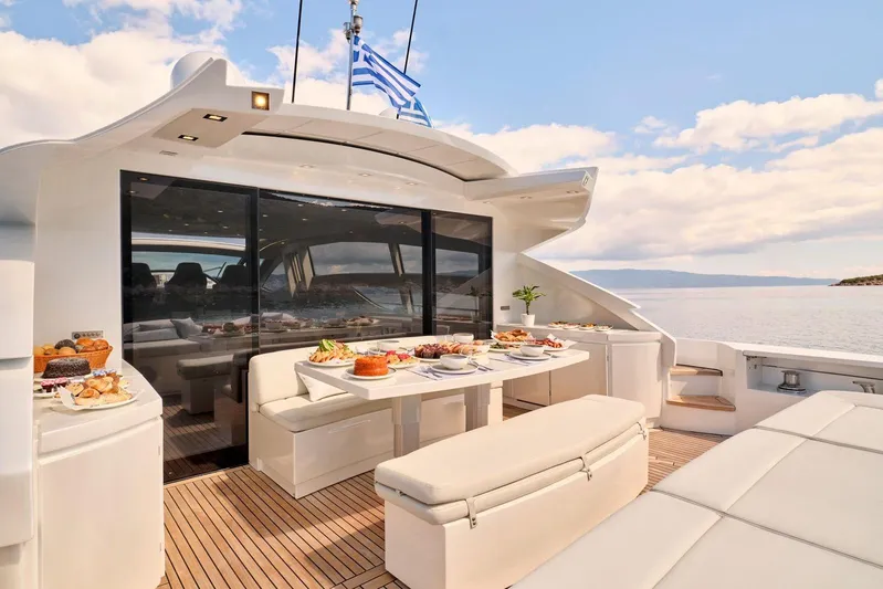 For Ever Yacht Photos Pics Luxurious 2008 Pershing 80 yacht deck with elegant dining setup and scenic ocean view.