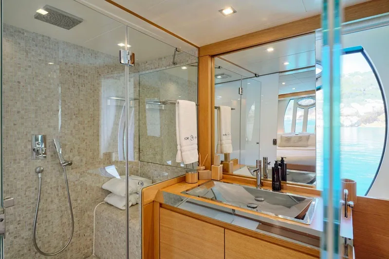 For Ever Yacht Photos Pics Luxurious bathroom interior on 2008 Pershing 80 yacht with modern fixtures and ocean view.