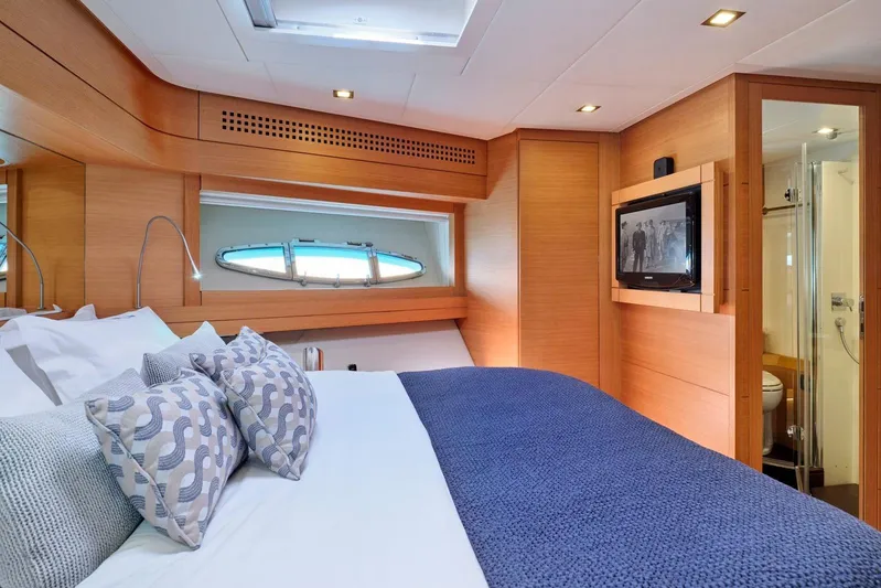 For Ever Yacht Photos Pics Luxurious cabin interior of 2008 Pershing 80 yacht with cozy bedding and modern amenities.