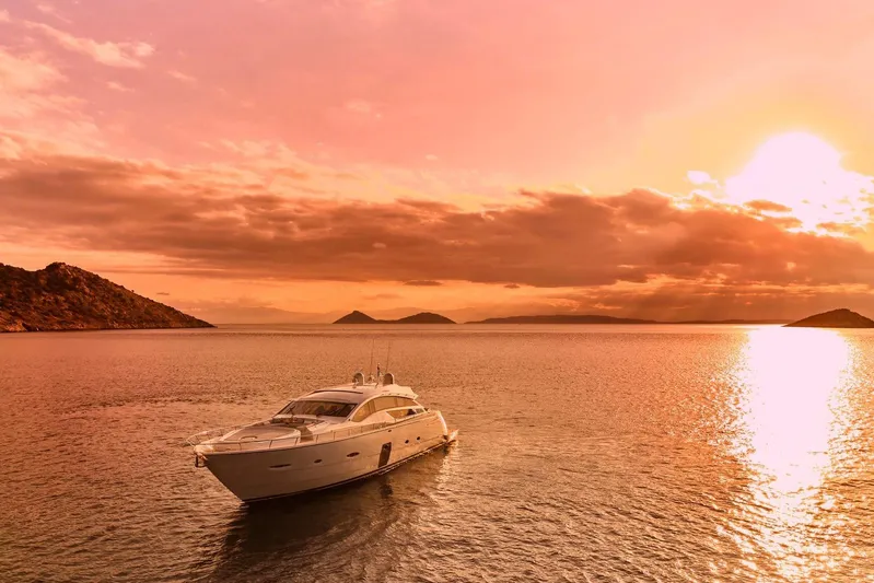 For Ever Yacht Photos Pics Luxurious 2008 Pershing 80 yacht cruising at sunset on tranquil waters.