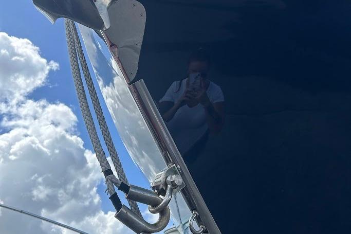 Reflection on 2017 Intrepid boat with clear sky and clouds.