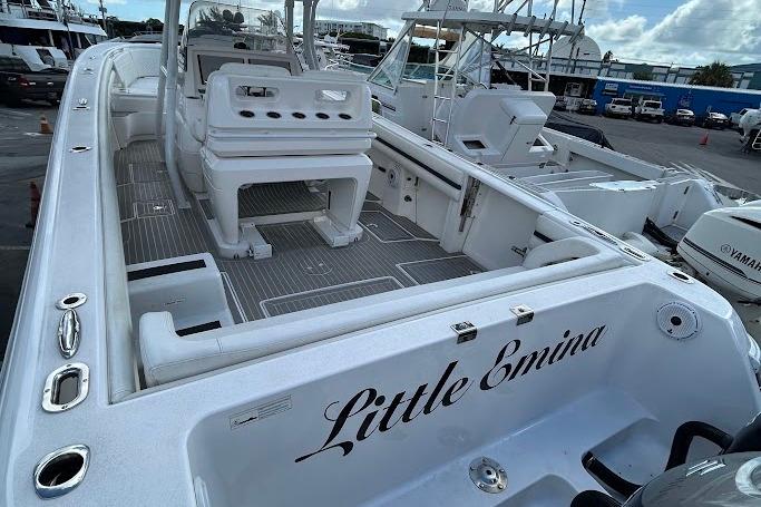 2017 Intrepid boat named "Little Emina" docked, featuring spacious deck and seating area.