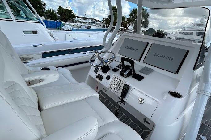 2017 Intrepid boat cockpit with dual Garmin displays and white leather seating.