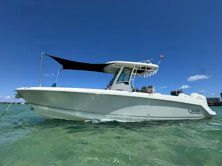  Yacht Photos Pics 2020 Boston Whaler 280 Outrage boat on clear water under blue sky.