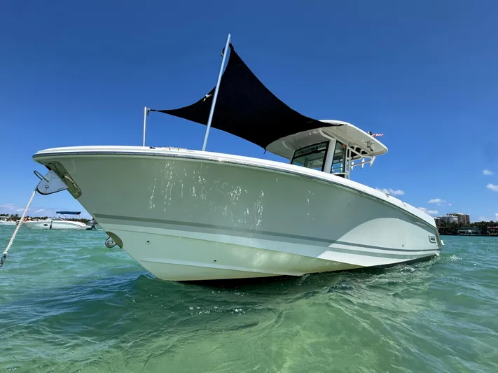  Yacht Photos Pics 2020 Boston Whaler 280 Outrage boat on clear water under blue sky.