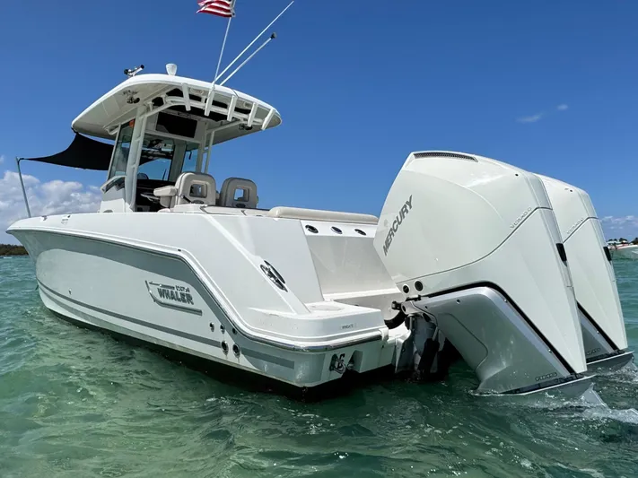  Yacht Photos Pics 2020 Boston Whaler 280 Outrage boat with dual Mercury engines on clear water.