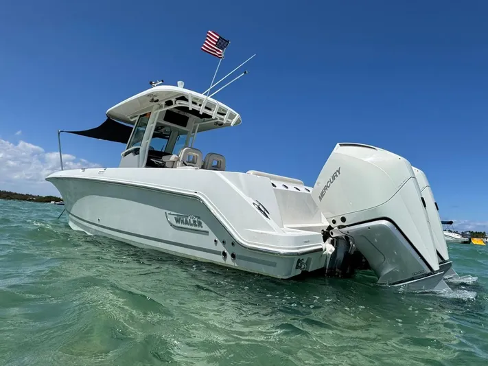  Yacht Photos Pics 2020 Boston Whaler 280 Outrage boat with Mercury engines on clear water.