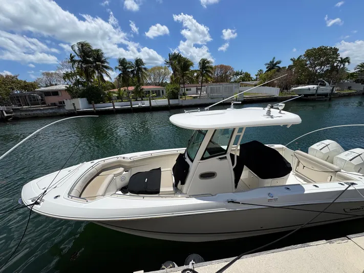  Yacht Photos Pics 2020 Boston Whaler 280 Outrage boat docked by a scenic waterfront.