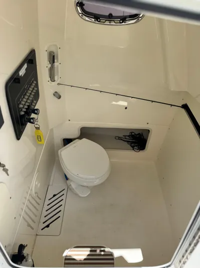  Yacht Photos Pics 2020 Boston Whaler 280 Outrage interior cabin with toilet and control panel.