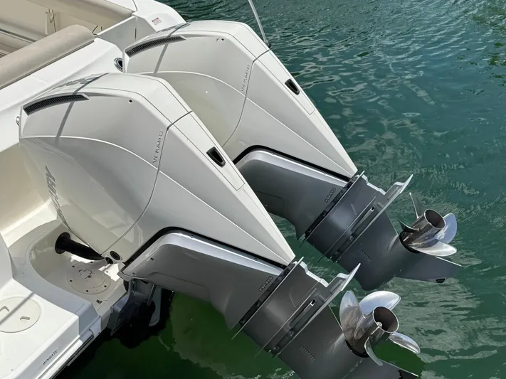  Yacht Photos Pics Twin outboard engines on a 2020 Boston Whaler 280 Outrage boat in water.