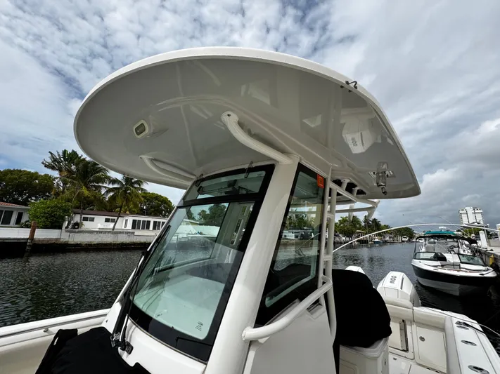  Yacht Photos Pics 2020 Boston Whaler 280 Outrage boat docked, featuring sleek design and spacious deck.