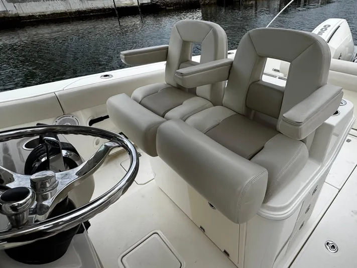  Yacht Photos Pics 2020 Boston Whaler 280 Outrage helm seating with dual chairs and steering wheel.