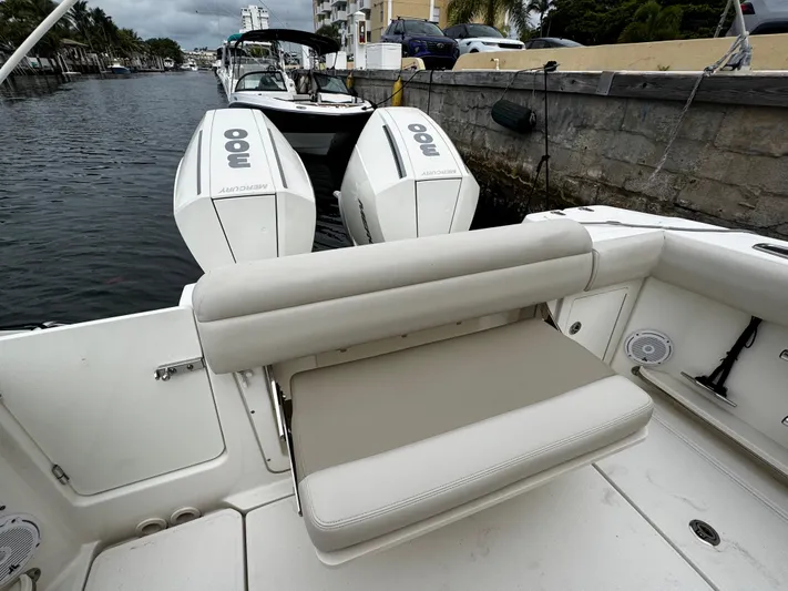  Yacht Photos Pics 2020 Boston Whaler 280 Outrage with dual Mercury engines, docked by a canal.