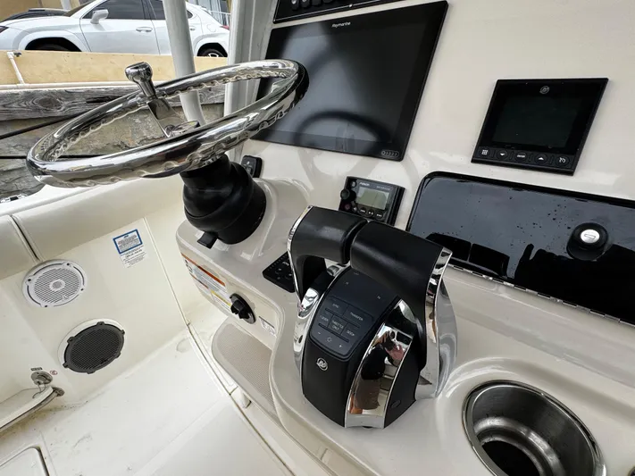  Yacht Photos Pics Control panel of a 2020 Boston Whaler 280 Outrage boat with steering wheel and electronics.