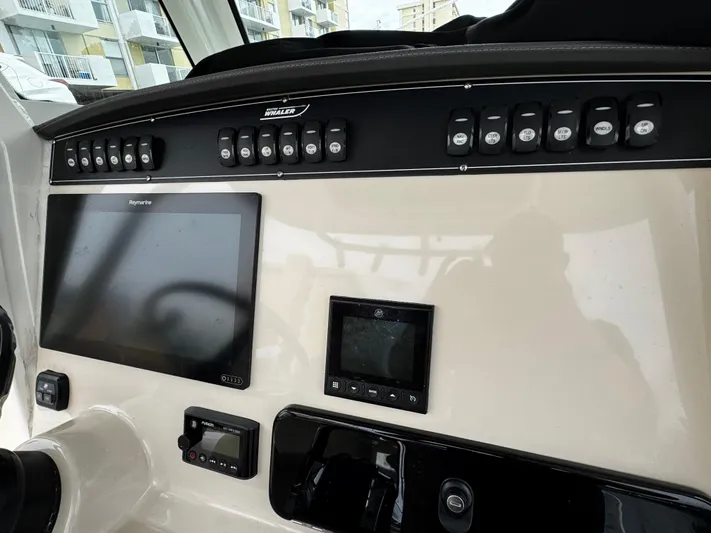  Yacht Photos Pics Control panel of a 2020 Boston Whaler 280 Outrage boat with navigation screens.