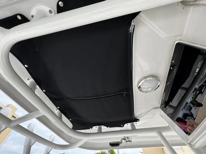  Yacht Photos Pics 2020 Boston Whaler 280 Outrage boat interior, featuring a black canopy and sleek design elements.