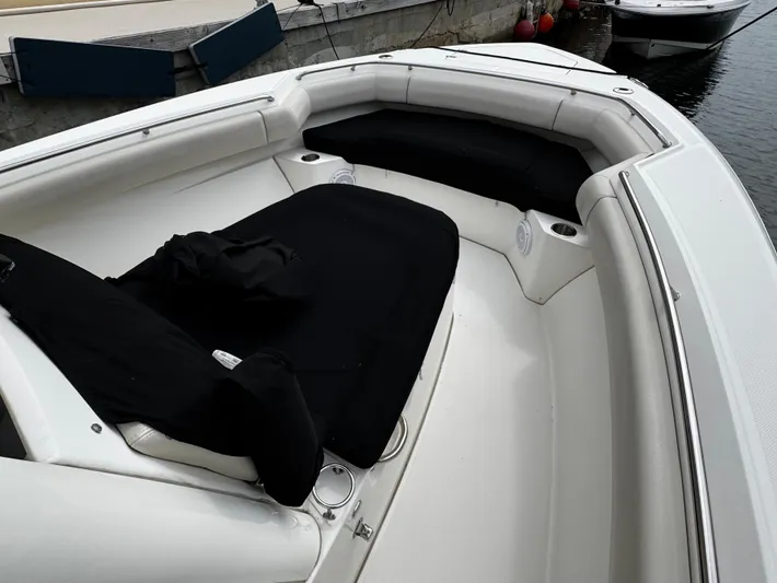  Yacht Photos Pics 2020 Boston Whaler 280 Outrage boat interior with cushioned seating and cup holders.