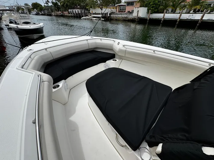  Yacht Photos Pics 2020 Boston Whaler 280 Outrage boat interior with cushioned seating and cup holders.