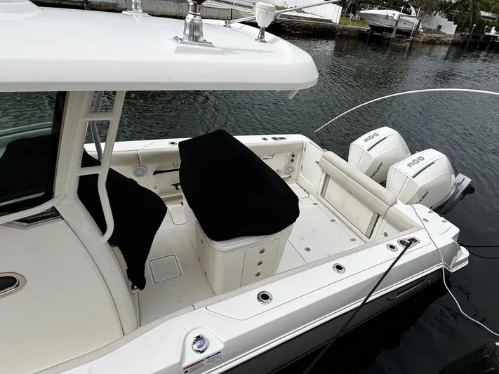  Yacht Photos Pics 2020 Boston Whaler 280 Outrage boat with dual Mercury engines docked by the water.