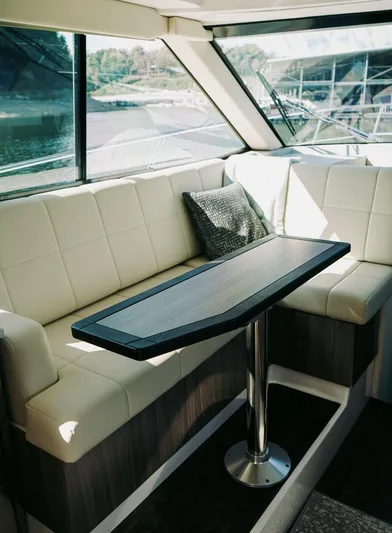  Yacht Photos Pics Interior of 2021 Regal 38 Grande Coupe with elegant seating and table.
