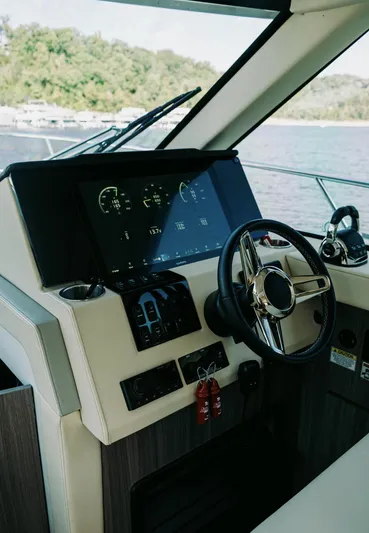 Yacht Photos Pics 2021 Regal 38 Grande Coupe helm with modern controls and scenic water view.