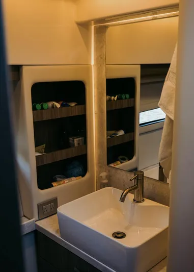  Yacht Photos Pics Bathroom interior of 2021 Regal 38 Grande Coupe with modern sink and storage shelves.