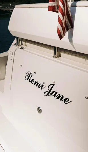  Yacht Photos Pics 2021 Regal 38 Grande Coupe yacht with "Remi Jane" name and American flag.