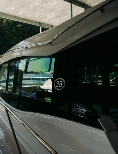  Yacht Photos Pics 2021 Regal 38 Grande Coupe yacht under a canopy, showcasing sleek design and modern features.