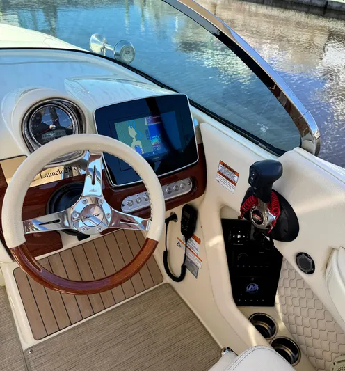  Yacht Photos Pics 2023 Chris-Craft Launch 28 GT dashboard with steering wheel and navigation display.