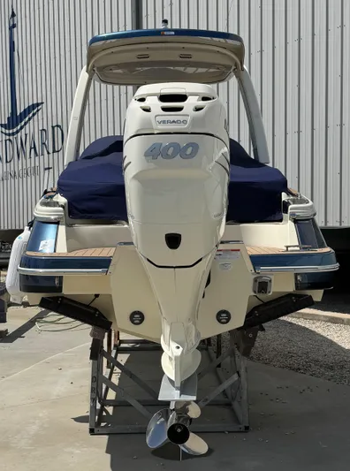  Yacht Photos Pics 2023 Chris-Craft Launch 28 GT boat with powerful outboard engine, docked on a stand.