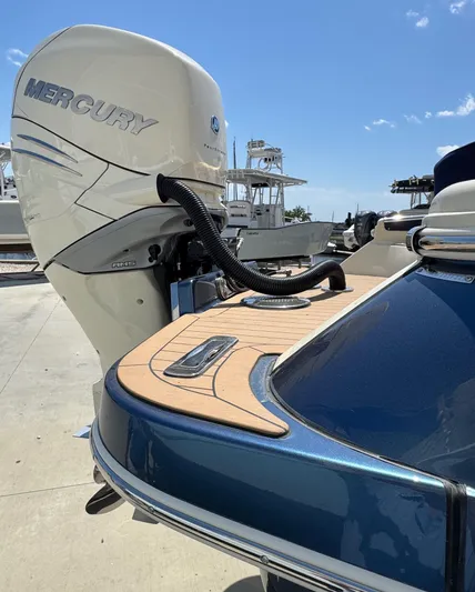  Yacht Photos Pics 2023 Chris-Craft Launch 28 GT with Mercury outboard engine, docked under clear blue sky.