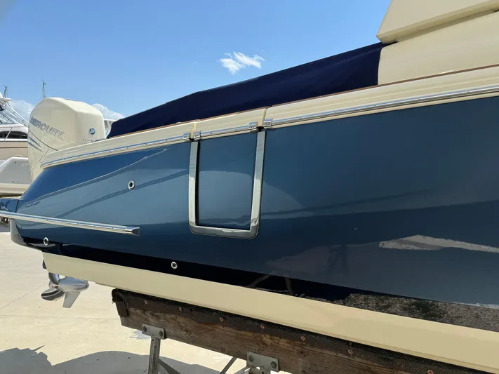  Yacht Photos Pics 2023 Chris-Craft Launch 28 GT boat, blue hull, docked under clear sky.