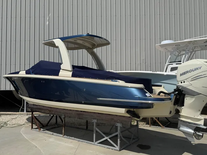  Yacht Photos Pics 2023 Chris-Craft Launch 28 GT boat with blue hull and Mercury engine, docked outdoors.