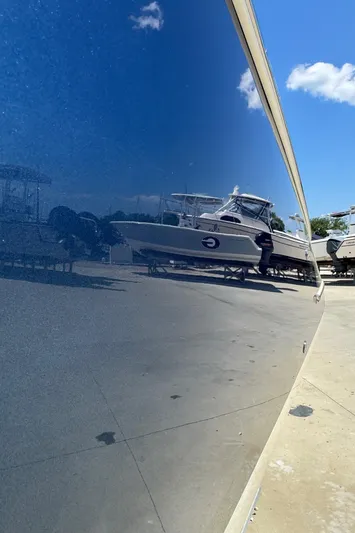  Yacht Photos Pics 2023 Chris-Craft Launch 28 GT boat reflecting on a glossy surface under a clear blue sky.