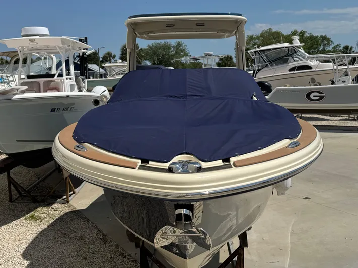  Yacht Photos Pics 2023 Chris-Craft Launch 28 GT boat with blue cover, docked among other boats.