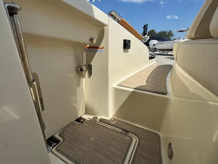  Yacht Photos Pics 2023 Chris-Craft Launch 28 GT interior, featuring elegant seating and deck details under a clear sky.