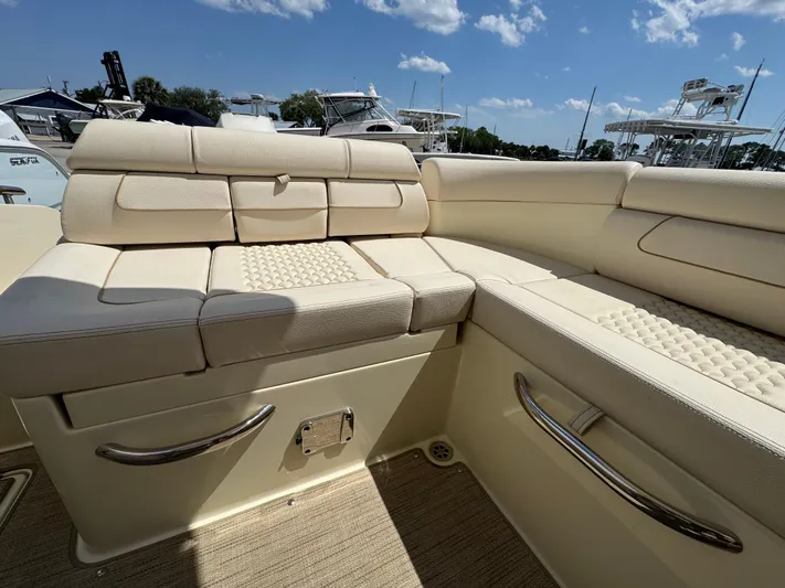  Yacht Photos Pics 2023 Chris-Craft Launch 28 GT interior with beige seating and stainless steel accents.