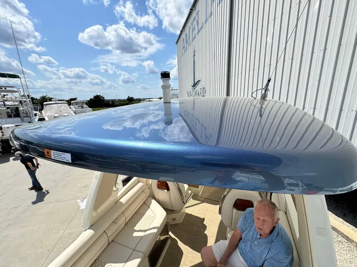  Yacht Photos Pics 2023 Chris-Craft Launch 28 GT boat with sleek blue hardtop under a sunny sky.