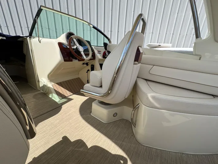  Yacht Photos Pics 2023 Chris-Craft Launch 28 GT interior with elegant seating and steering wheel.