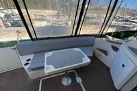 2007 Cruisers Yachts 447 Sport Sedan interior with seating and table on deck.