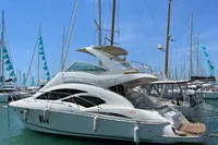 2007 Cruisers Yachts 447 Sport Sedan docked in a marina under clear blue skies.